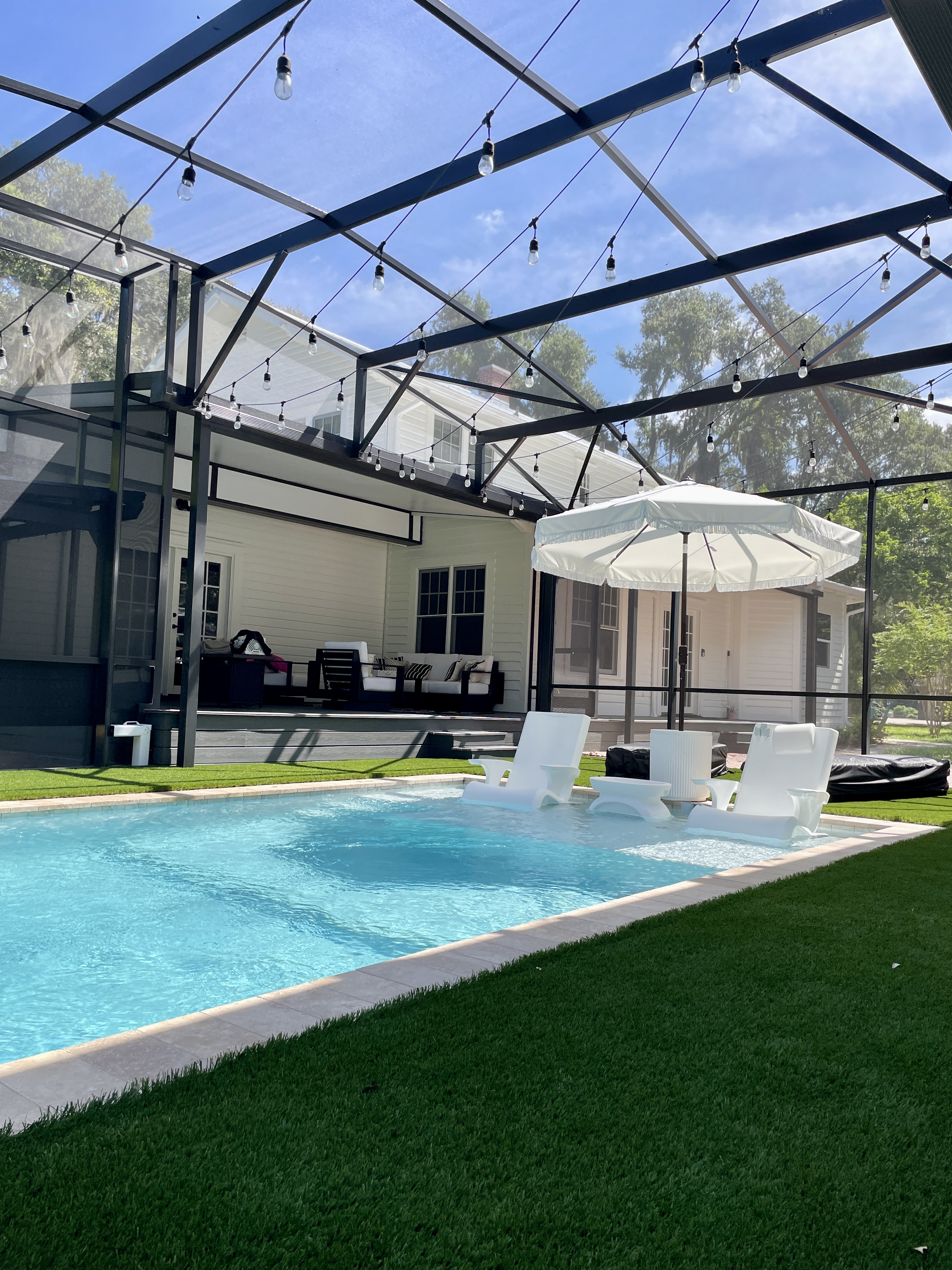Modern pool screen enclosure installation with aluminum frame structure